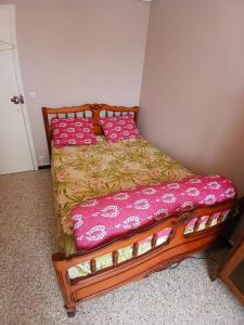 a bedroom with a bed with pink pillows on it at lits superposé in Marseille +3 photos