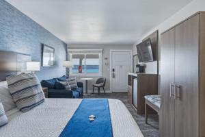 a hotel room with a bed and a tv at The Water Street Inn in Ephraim
