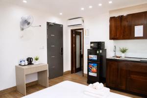 a kitchen with a black refrigerator and a counter at Khách Sạn Cát House in Ha Long