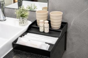 a black box with cups and towels on a bathroom vanity at Khách Sạn Cát House in Ha Long +168 photos