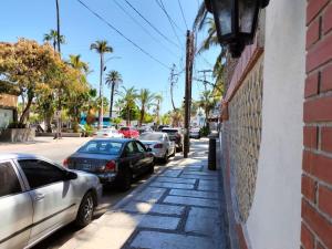 a street with cars parked on the side of a building at Sandy Shores Cabaña 7 in La Paz +31 photos
