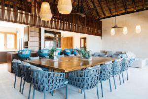a dining room with a large wooden table and chairs at Beachfront Villa Soliman Bay- 8 bedrooms in Balcheil