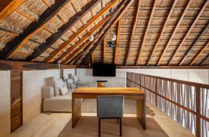a dining room with a wooden table and a chair at Beachfront Villa Soliman Bay- 8 bedrooms in Balcheil