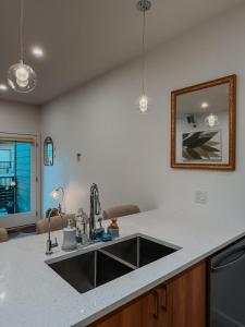 a kitchen with a sink and a counter top at Private Boho Tiny Home - Lakes, Wineries, Hike, Ski in Kelowna +65 photos