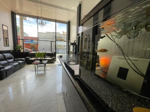 a living room with a couch and a glass table at Hotel Ejecutivo 63 In in Bogotá