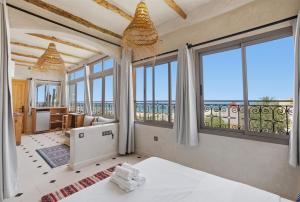 a bedroom with a view of the ocean at Surf Appart Morocco in Tamraght Ouzdar +68 photos