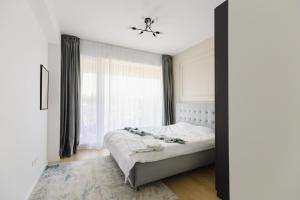 a bedroom with a bed and a window at Cozy Getaway Sector 1 in Bucharest +35 photos