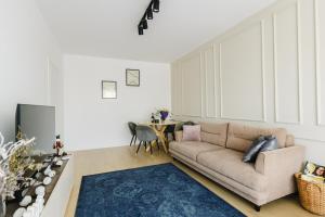 a living room with a couch and a table at Cozy Getaway Sector 1 in Bucharest