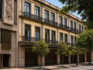 a large building with a bunch of windows on it at Hotel Bellas Artes in Mexico City