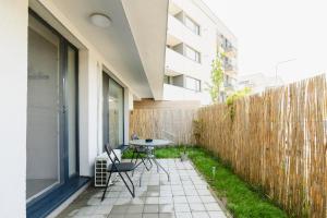 a small patio with a table and chairs in front of a building at Cozy Getaway Sector 1 in Bucharest