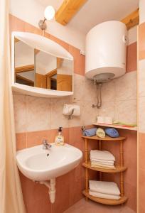 a bathroom with a sink and a mirror at Holiday Home Grubišić in Mirce +28 photos