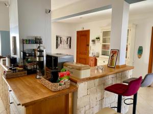 a kitchen with a counter and a red stool at Seaview Luxury Penthouse Mare in Sal Rei