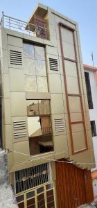 a tall building with windows and a fence at Govind atithi greh in Ayodhya