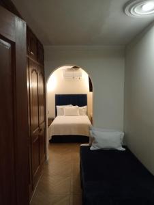 a hotel room with a bed and an archway at Hotel Casa Victoria in Tequila +7 photos