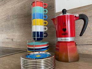 a multicolored coffee maker next to a stack of plates at Seaview Luxury Penthouse Mare in Sal Rei +49 photos