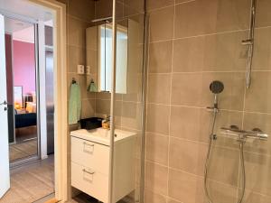 a bathroom with a shower and a sink and a mirror at The Seabreeze Terrace Apartment in Turku +43 photos