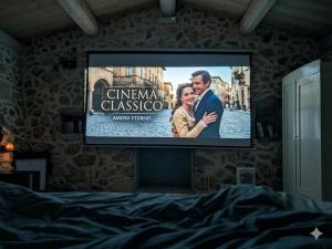 a tv screen with a movie on it in a bedroom at Masseria Petra in Martano