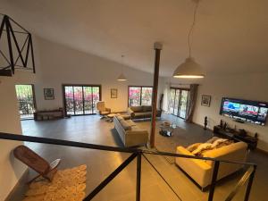 a living room with a couch and a tv at Chez Diarra in Saint-Louis