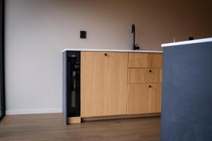 a kitchen with a microwave and a black refrigerator at Reed Panorama in Reed +14 photos