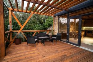 a wooden deck with chairs and a table at Terra House in Andrushovka