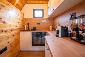 a kitchen with wooden walls and wooden counters at Zov planine in Žabljak
