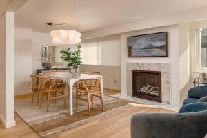 a living room with a table and a fireplace at Crows Nest Condo 3BR Downtown in Anchorage