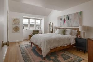 a bedroom with a bed and a dresser and a window at Crows Nest Condo 3BR Downtown in Anchorage