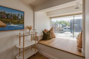 a window seat in a room with a large window at Crows Nest Condo 3BR Downtown in Anchorage