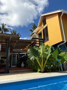a house and a swimming pool in front of a house at Sea Turtle Lodge and Villas in Rarotonga