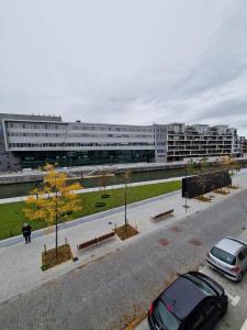 a parking lot with cars parked in front of a building at Studio Kortrijk in Kortrijk