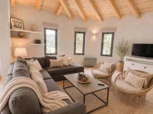 a living room with a couch and a table at Le Blanc in Dassia
