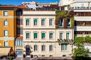 an apartment building with green shutters in a city at The B Place in Rome