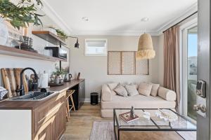 a living room with a couch and a table at SW Beach Hotel in Hermosa Beach