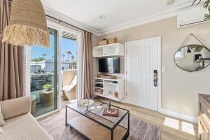 a living room with a couch and a table at SW Beach Hotel in Hermosa Beach