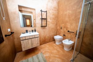 a bathroom with a toilet and a sink and a shower at Villa Elen in Marsala +92 photos