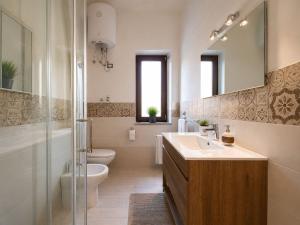 a bathroom with a sink and a toilet and a mirror at Life Vesuvio in Torre del Greco