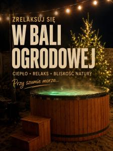 a christmas tree and a sign that says ball october at Domki na wydmie in Dziwnówek