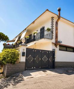 a house with a black gate in front of it at Life Vesuvio in Torre del Greco