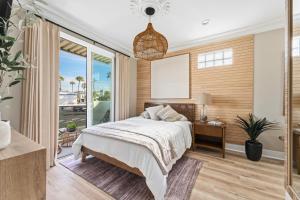 a bedroom with a bed and a large window at SW Beach Hotel in Hermosa Beach