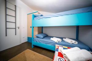 a bunk bed with blue bunk beds in a room at Villa Elen in Marsala