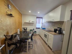 a kitchen with a table and some chairs in it at Ferienwohnung Gabry in Saarlouis