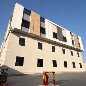a large building with windows on the side of it at AURA Stay in Dammam