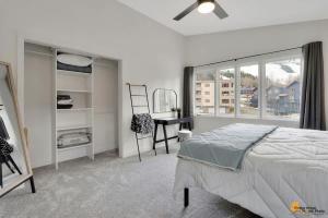 a bedroom with a bed and a desk and a window at Alyeska Slope-Side Sanctuary in Girdwood