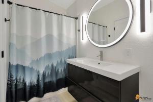 a bathroom with a sink and a shower curtain at Alyeska Slope-Side Sanctuary in Girdwood +40 photos