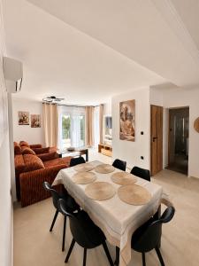 a living room with a table and chairs and a couch at Armonia Complex in Gavalochori