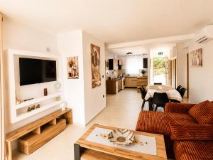 a living room with a couch and a table at Armonia Complex in Gavalochori