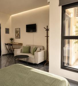 a living room with a couch and a table at ATHENIAN Vibes in Athens