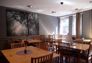 a dining room with wooden tables and chairs at Hotel Expo Stockholm in Stockholm