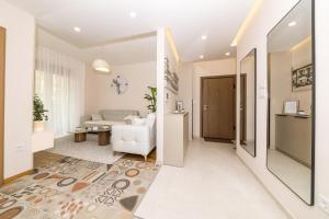 a hallway with a living room with a couch at Luxury Apartment Milos in Dobrota