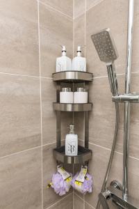 a bathroom with a shelf with toiletries on it at Luxury Apartment Milos in Dobrota +74 photos